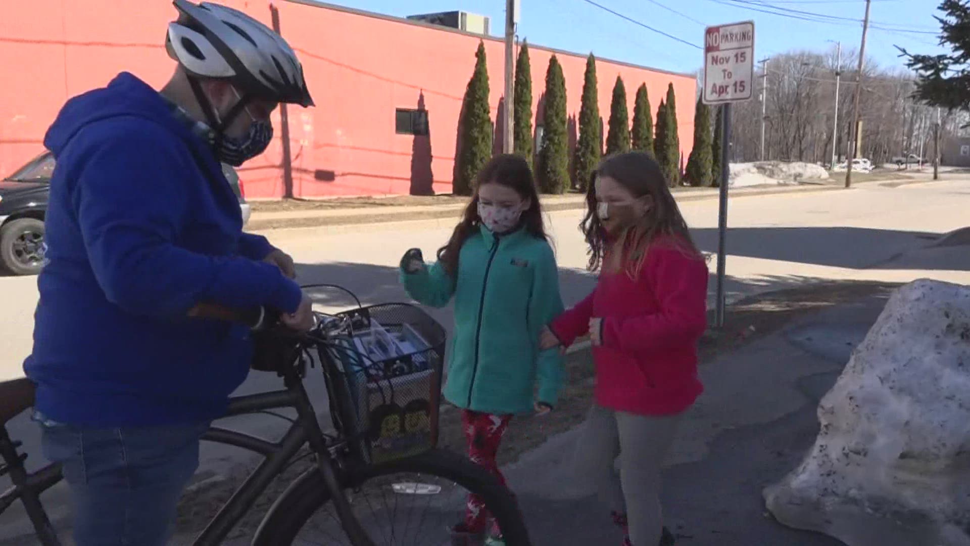 With a little help from the community in the form of a bicycle donation, teachers and administrators have been making the rounds with a basket of books.