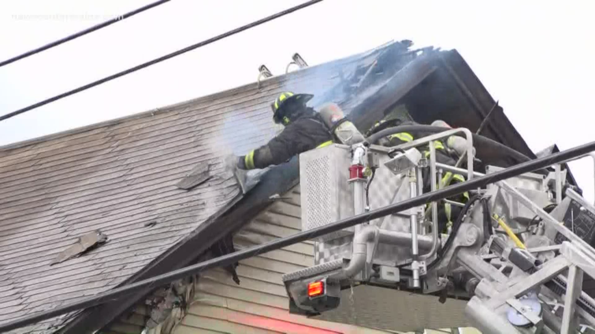 Fire crews from several towns work to put out the fire at a building on Stillwater Ave. in Old Town